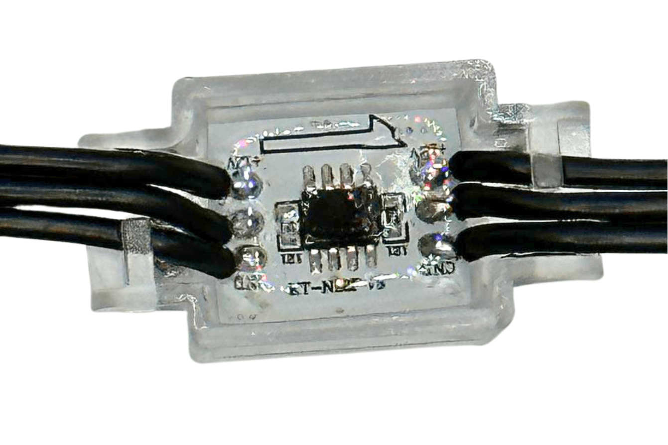 Attached image file Close-up of an electronic component encased in clear plastic, showing a small circuit board with a microchip and six black wires connected to it on both sides, with a black arrow printed on the casing.